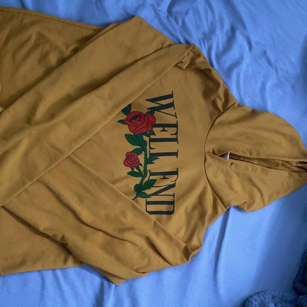this is a long sleeve yellow crop top, its thin but not see through